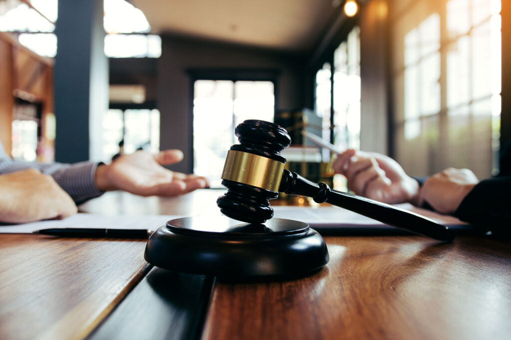 civil litigation concept with law gavel and people discussing in background